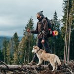 hiker-with-siberian-husky-dog-looking-at-beautiful-view-in-mountains